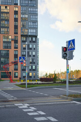 urban intersection pedestrian crossing with traffic lights against modern apartment building...