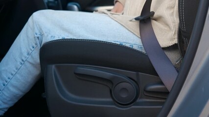 Passenger fastening seat belt in modern car. Detailed view showing responsible passenger carefully buckling seatbelt inside modern vehicle interior, highlighting critical road safety precautions
