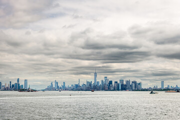 Wide panoramic view of the New York City skyline with skyscrapers surrounding Battery Park in Lower Manhattan.