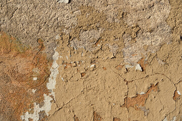 An old painted wall with peeling paint as a background.