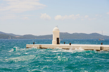 Waves and spray around a lighthouse in Zadar, Croatia.