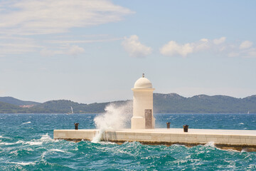 Waves and spray around a lighthouse in Zadar, Croatia.