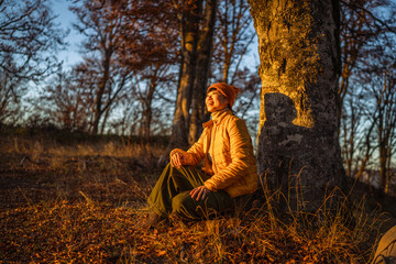 Woman smiling relaxing a golden hour forest
