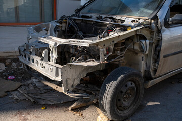 Disassembled vehicle engine bay in auto garage. Car with removed engine waiting for repair in workshop. Broken car under maintenance without engine.