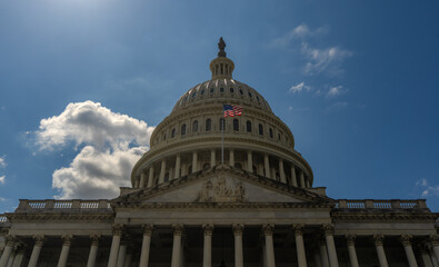 Fototapeta premium Washington DC Capitol building. Congress on Capitol Hill. American flag over Capitol. United States government Capitol landmark. Senate and House in Washington.