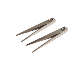 Two angled metal tools, light gray/silver color,  overlapping,  sharp points