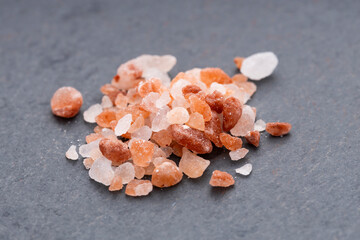 Pile of pink Himalayan salt on a slate background