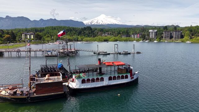 Aerial view of the port of the city of Puc&oacute;n, with the imposing Villarrica volcano in the background.