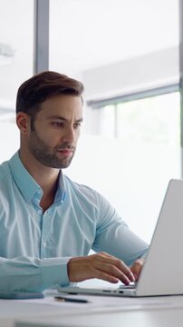 European businessman ceo specialist using computer technology app for work online. Young professional specialist latin hispanic businessman working on laptop pc sitting at desk in office. Vertical