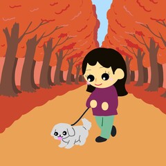 もみじの絨毯を犬と散歩する人