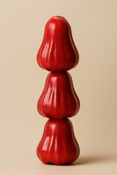 Stacked Glossy Red Wax Apples (Java Apple) on a Soft Pale