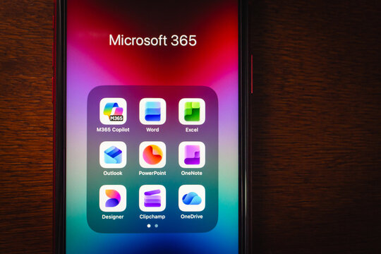 Quito, ECUADOR - Oct 28 2025 : Close-up of Microsoft 365 app folder with icons like Word, Excel, Outlook, PowerPoint, OneNote, OneDrive, Clipchamp, MS Designer and Copilot visible.