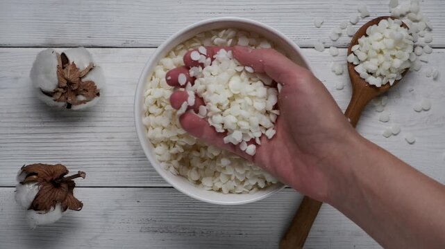 Granules of the soy wax in a bowl. Preparation for making candles. Candle making hobby.
