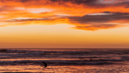 Surfer hitting the waves during sunset
