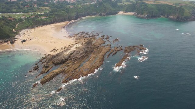 Aerial footage of Amio Beach on sunny summer day. Pechon, Cantabria, Spain.