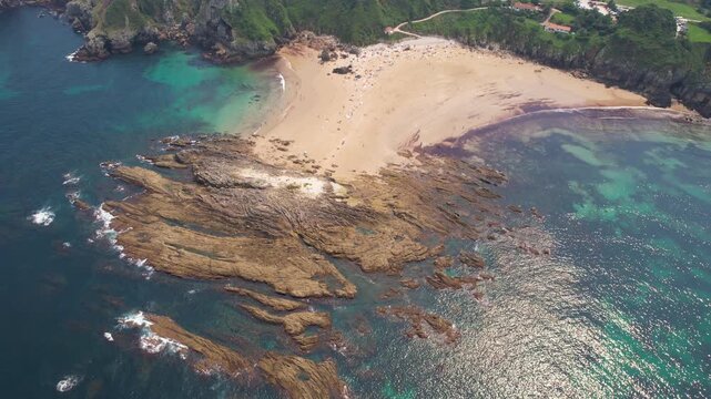 Drone footage of Amio Beach on sunny summer day. Pechon, Cantabria, Spain.