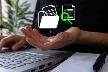 Woman working on a computer holding a magnifying glass icon, files, and folders. Concept of analyzing archived documents.