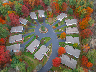 Aerial view of suburban housing community in autumn season with colorful trees