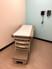An examination table and a blood pressure monitor in a medical clinic