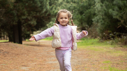 Joyful child running in nature's forest pathway. Nature