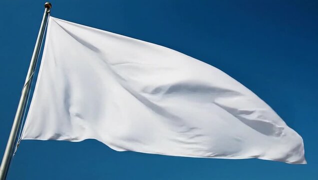 White Flag Waving in the Wind Against Blue Sky.