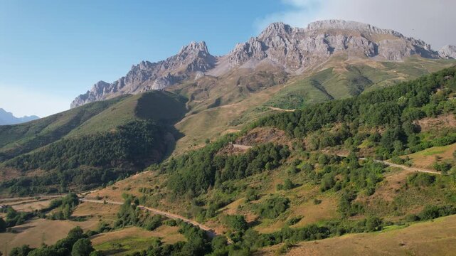 Rising up aerial shot of Picos de Europa on sunny summer evening. Santa Marina de Valdeon, Leon, Spain.
