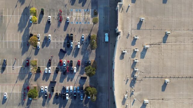 Large retail strip mall in Lewisville, Texas features modified bitumen roof, multiple rooftop HVAC systems units, facade-facing parking with electric and gas vehicles, and zoning-compliant layout