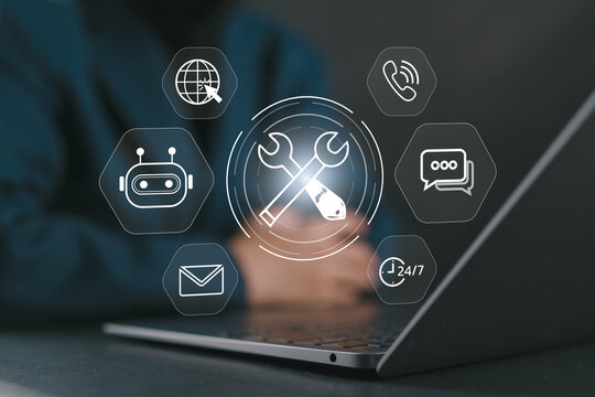 IT support and digital tools concept. Woman using laptop with glowing wrench and screwdriver, representing system maintenance, tech service, customer support, and online troubleshooting in business