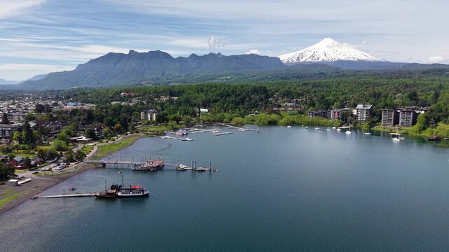 Aerial view of the port of the city of Puc&oacute;n, with the imposing Villarrica volcano in the background.