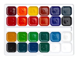 A close-up shot of a watercolor paint palette, filled with vibrant, square-shaped colors arranged in rows