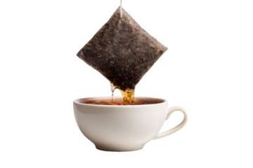 Tea bag pouring into a white cup