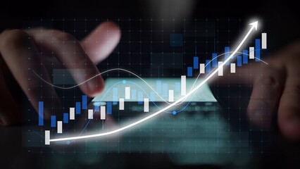 Close-up view of hands interacting with a smartphone displaying stock market trends and financial graphs, showcasing the significance of technology in investment strategies. Copula