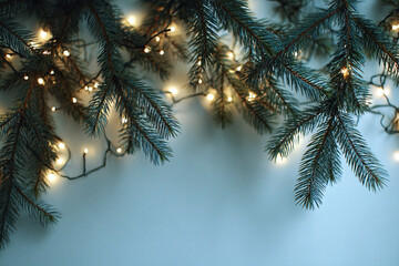 serene seasonal backdrop with illuminated pine branches and tranquil blue background