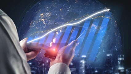 A business professional interacts with a smartphone displaying financial data trends and growth graphs while in a modern office environment. Copula