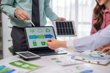 Business professionals discussing esg strategy with solar panel model
