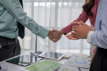 Business people shaking hands celebrating green energy esg deal