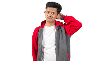 Thoughtful young man scratching his head, looking confused in stylish varsity jacket, isolated on white background, perfect for expressing uncertainty