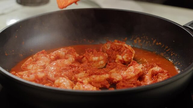 Tamarind red prawn curry cooking, shrimps in tomato ginger sauce, asian kitchen, Chinese restaurant.