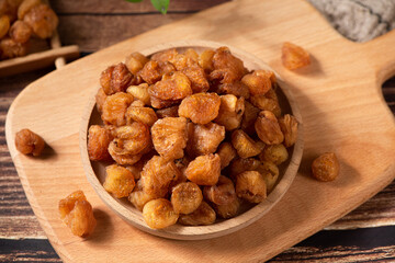 Dried Longans on wooden table.
