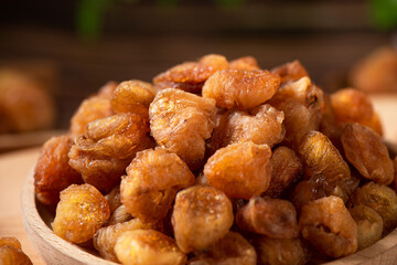 Dried Longans on wooden table.