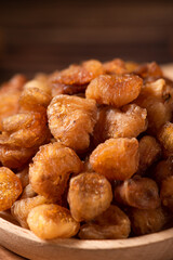 Dried Longans on wooden table.
