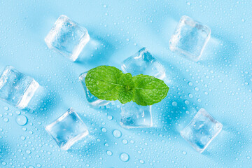 Ice cubes and fresh mint leaves on blue background