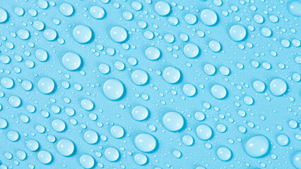 close up of water drops on blue background.