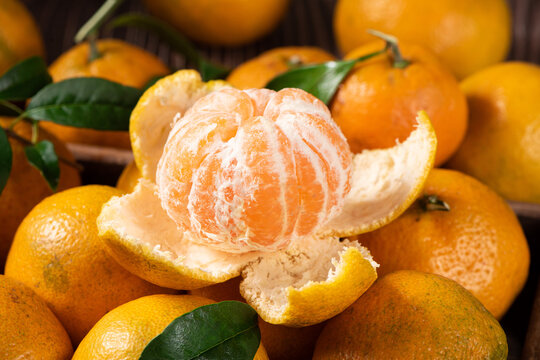 Fresh mandarin oranges or tangerines on wooden table.