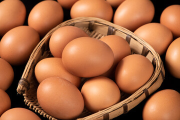 closeup of raw brown chicken eggs on table.