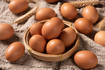 closeup of raw brown chicken eggs on table.