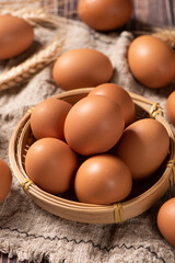 closeup of raw brown chicken eggs on table.
