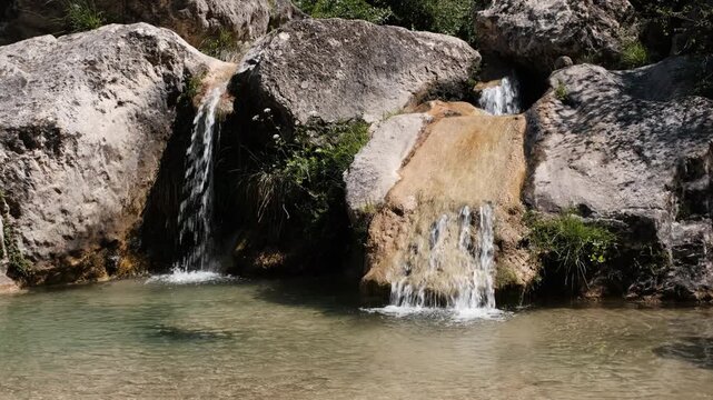 Footage of small waterfalls in Gorg Gorge on sunny summer day. La Febr&oacute;, Tarragona, Spain.