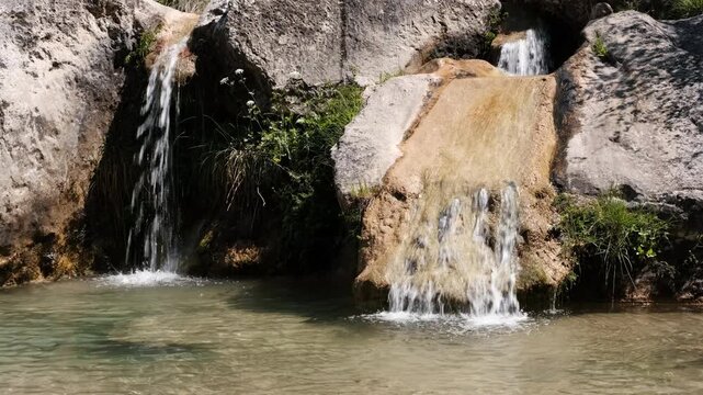 Close up tripod shot of small waterfalls in Gorg Gorge on sunny summer day. La Febr&oacute;, Tarragona, Spain.