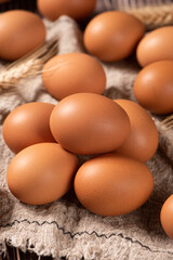 closeup of raw brown chicken eggs on table.